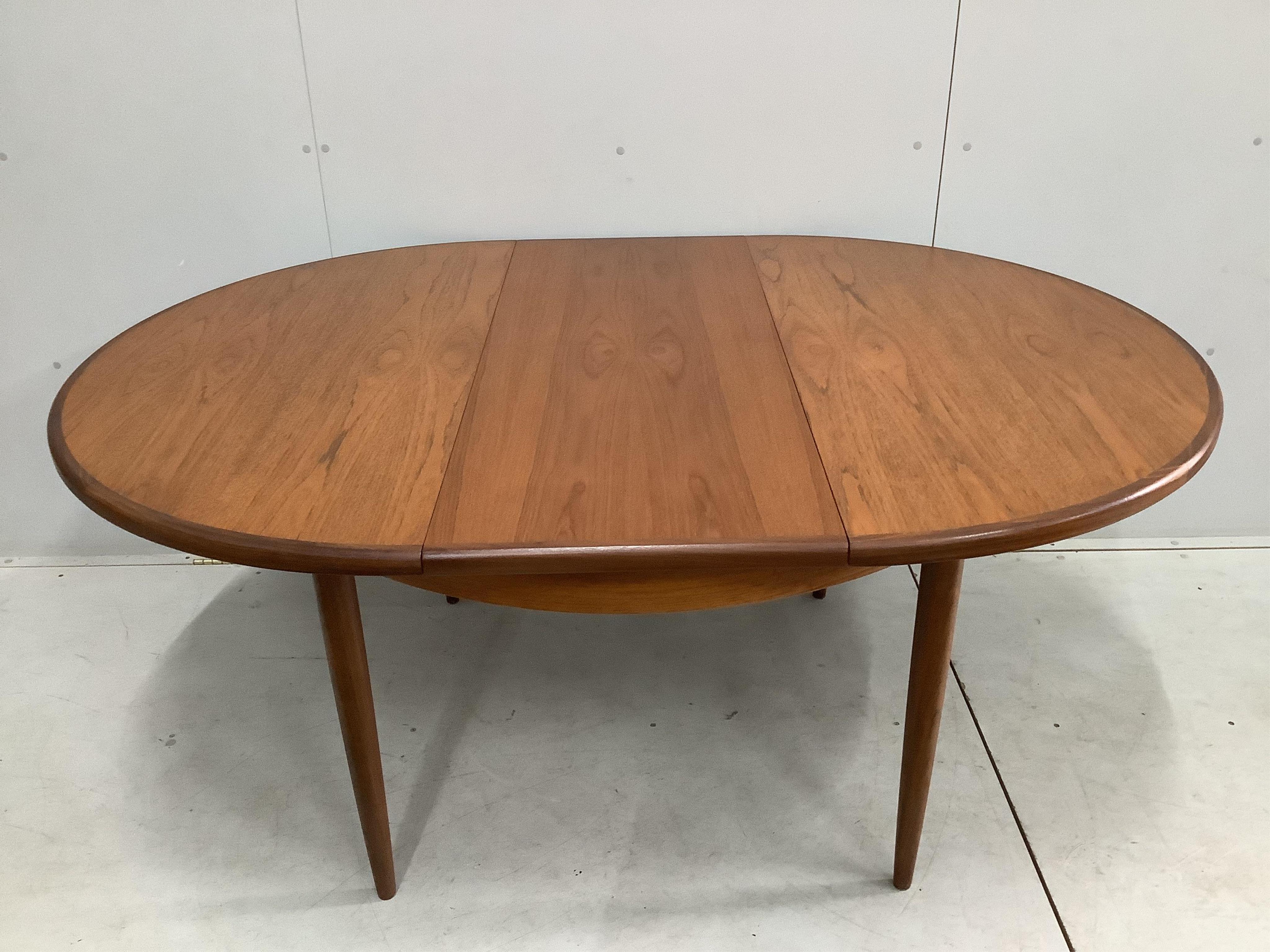 A G Plan Fresco teak dining table and five chairs, one with arms. Table 170cm extended, depth 120cm, height 73cm. Condition good.